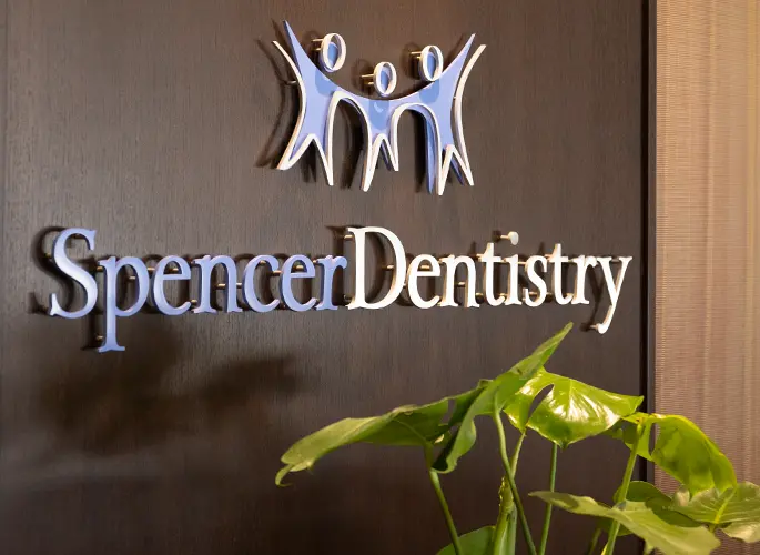 Spencer Dentistry logo mounted on wall